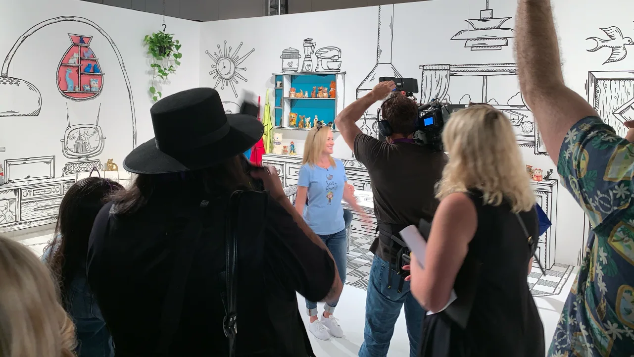 A woman stands in a room of custom fabrication by Fuller Street at Catcon Pasadena