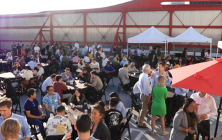 A crowd of attendees at the Peteresen Automotive Museum event by Fuller Street