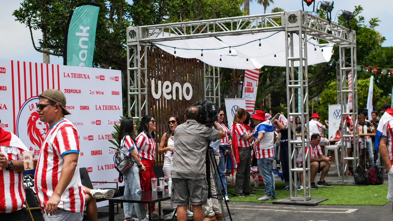 A broadcast team captures fan interviews in front of the Ueno Bank Outdoor Lounge at the Casa Albirroja Fan Experience in Los Angeles