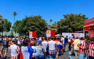 Paraguay World Cup fans make their way towards the entrance of the Casa Albirroja Fan Experience in Santa Clara with entry towers built by Fuller Street
