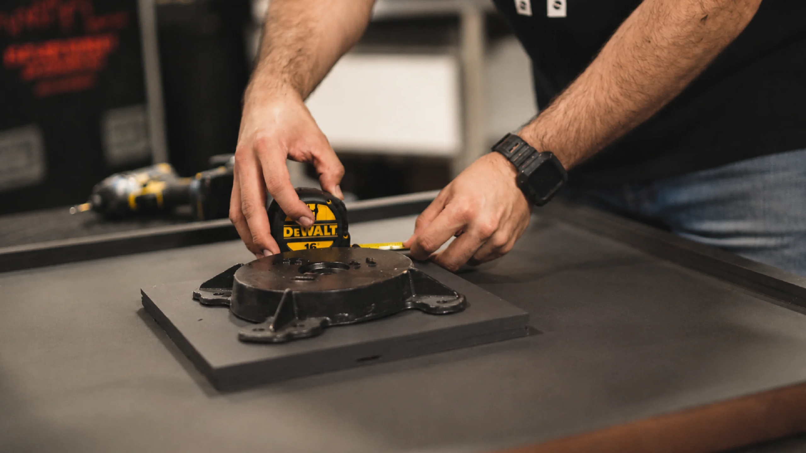 A fabrication expert measures material for experiential fabrication services by Fuller Street in Los Angeles