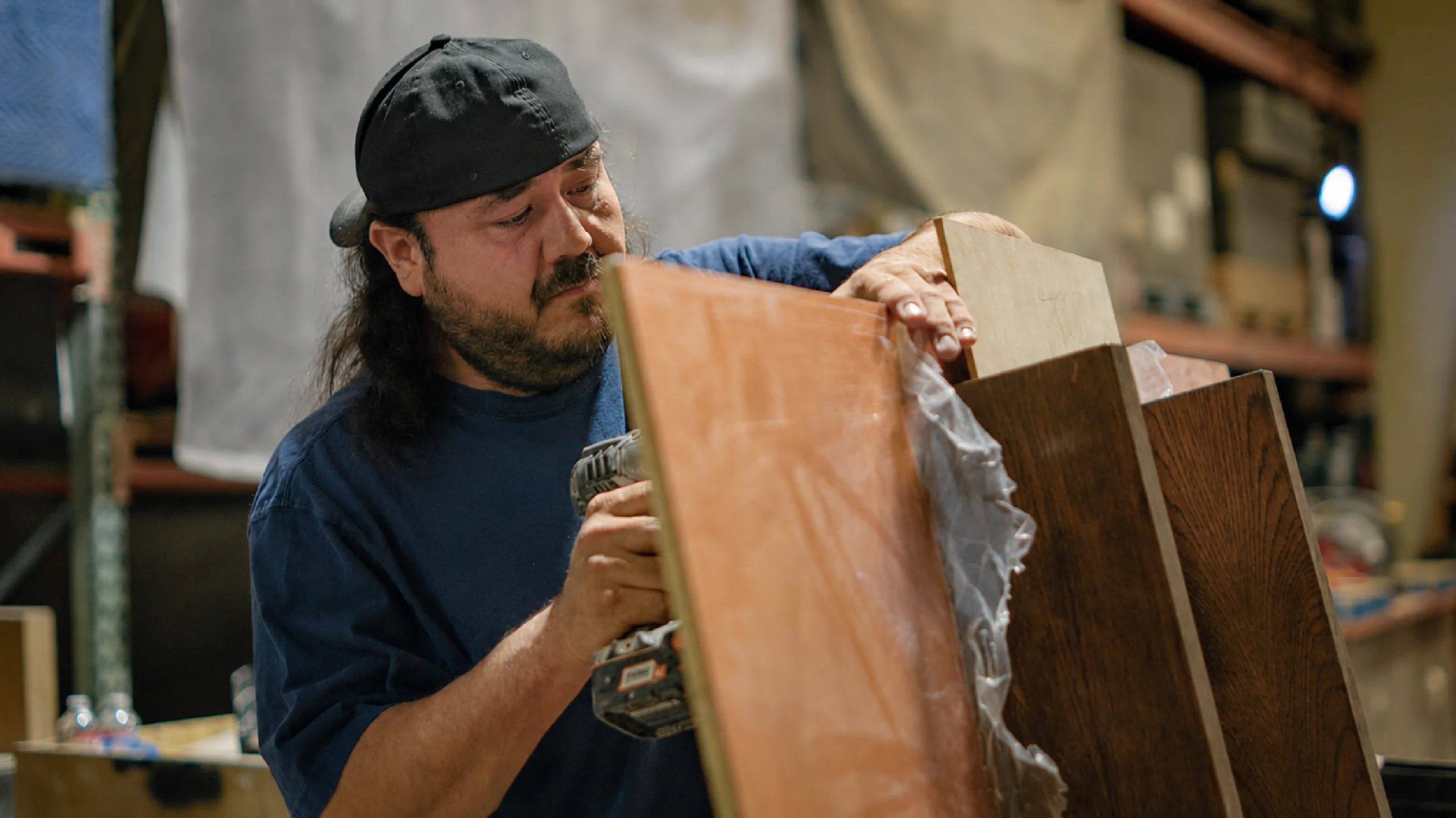 A carpenter assembles pieces for experiential fabrication services by Fuller Street in Los Angeles